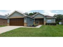 Charming single-story home featuring a well-maintained lawn and attached two car garage at 4085 Sw 49Th Ave, Ocala, FL 34474