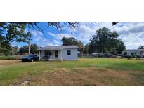 Single-story home with large yard, front porch, and ample parking at 10455 Se 108Th Ter Rd, Belleview, FL 34420