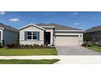 Charming single-story home with stone accents, a two-car garage, and a well-manicured front lawn at 4122 Nw 48Th Terrace Rd, Ocala, FL 34482