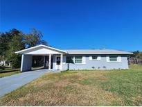 Cute ranch home with carport and well-maintained lawn at 711 Ne 43Rd St, Ocala, FL 34479