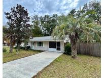 Ranch style home with mature landscaping and a long driveway at 6780 Nw 60Th St, Ocala, FL 34482