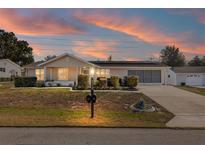 Ranch style home with solar panels and landscaped yard at 8968 Sw 116Th Place Rd, Ocala, FL 34481