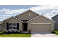 Charming single-story home featuring a two-car garage, well-manicured lawn, and beautiful landscaping at 8878 Sw 48Th Ave, Ocala, FL 34476