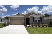 Charming single-story home featuring a two-car garage and beautiful stone accents at 9291 Sw 60Th Court Rd, Ocala, FL 34476