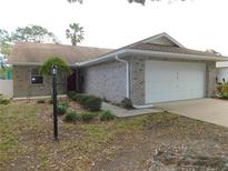 Brick house with attached garage and landscaping at 9101 Sw 91St Cir, Ocala, FL 34481