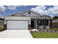 Charming single-story home featuring a two-car garage and professionally landscaped front yard at 9287 Sw 60Th Court Rd, Ocala, FL 34476