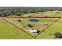 House situated on a large lot with pond at 4027 N C 470, Lake Panasoffkee, FL 33538