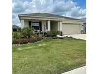 Charming single-story home features a manicured lawn and beautiful landscaping at 7682 Sw 89Th Ct, Ocala, FL 34481