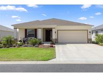 Charming single-story home featuring a well-manicured lawn and an attached two-car garage at 7682 Sw 89Th Ct, Ocala, FL 34481