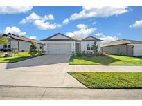 Two-car garage and neutral color scheme in a residential neighborhood at 8456 Sw 52Nd Lane Rd, Ocala, FL 34481