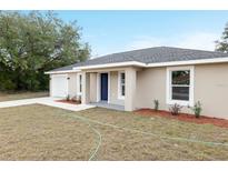 Charming single-story home with a well-maintained lawn, attached garage, and a welcoming front entrance at 14977 Sw 21St Pl, Ocala, FL 34481