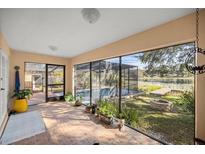 Bright screened porch overlooking a pool and lake at 37352 Turner Dr, Umatilla, FL 32784