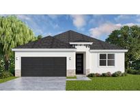 Single-story home with dark garage door, white walls, and landscaping at 13143 Sw 67Th Ave, Ocala, FL 34473