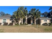 Beautiful one-story home with palm trees and a well-manicured lawn at 2105 Sw 4Th St, Ocala, FL 34471