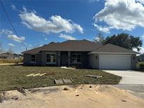 Charming single-story home with a two-car garage, a well-manicured lawn and freshly planted sod at 3 Willow Trl, Ocala, FL 34472