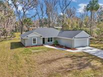 Beautiful home with a well-maintained lawn, concrete driveway, and lovely landscaping at 4065 Sw 5Th Ave, Ocala, FL 34471
