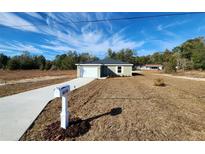 Newly constructed home with attached garage and a neat lawn at 4698 Sw Zinnia, Dunnellon, FL 34431