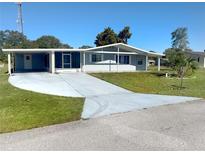 Charming single-story home with covered parking, a well-manicured lawn, and mature landscaping at 8973 Sw 101St Ln, Ocala, FL 34481
