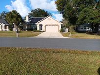 One-story house with solar panels and a two-car garage at 98 Bahia Trace Cir, Ocala, FL 34472