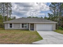 Newly constructed single-story home with a two-car garage at 13104 Sw 82Nd Court Rd, Ocala, FL 34473