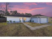 Newly renovated single-story home with a landscaped lawn and attached garage at 15154 Sw 38Th Cir, Ocala, FL 34473