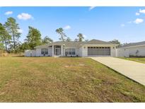 Newly constructed home with a spacious yard and attached garage at 16689 Sw 22Nd Terrace Rd, Ocala, FL 34473