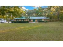 Single-story house with green roof, large yard, and ample parking at 1981 Se 54Th Ter, Ocala, FL 34480