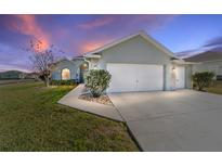 Charming single-story home with a two-car garage and manicured lawn at 2111 Nw 58Th Ct, Ocala, FL 34482