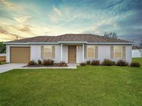 Cute one-story house with attached garage and manicured lawn at 5 Walnut Ct, Ocala, FL 34480