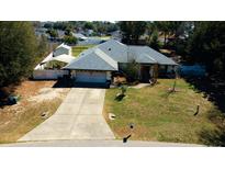 A charming single-story home with a two-car garage and a well-manicured front lawn at 5491 Sw 100Th Loop, Ocala, FL 34476