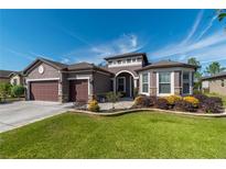 Two-story home with three-car garage and landscaped yard at 6758 Sw 94Th Cir, Ocala, FL 34481