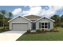 Single-story home with gray siding, two-car garage, and landscaped yard at 8489 Las Palmas Way, Wildwood, FL 34785