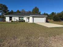 One-story house with attached garage and grassy yard at 2520 Sw 143 Ave, Ocala, FL 34481