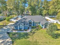 Single-story home with a spacious backyard, pool, and detached shed at 5579 Se 44Th Cir, Ocala, FL 34480