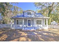 Charming craftsman home features a welcoming front porch and landscaped yard at 12195 Sw 39Th Ln, Ocala, FL 34481