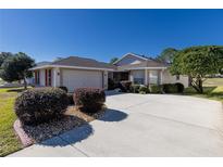 Single-story home with attached garage and landscaped yard at 15440 Sw 14Th Avenue Rd, Ocala, FL 34473