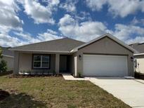 Charming one-story home featuring a two-car garage and well-maintained lawn at 2142 Nw 23Rd Loop, Ocala, FL 34475