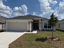 Charming single-story home with a well-manicured lawn and attached two-car garage at 2146 Nw 23Rd Loop, Ocala, FL 34475