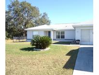 House exterior with driveway, landscaping and a carport at 221 Locust Ln, Ocala, FL 34472