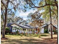 Beautiful single-story home with a lush front yard, mature trees, and a well-maintained lawn at 4400 Sw 20Th Ave, Ocala, FL 34471