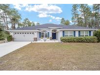 One-story home with gray siding, gray roof, and a two-car garage at 4585 Sw 112Th Ln, Ocala, FL 34476