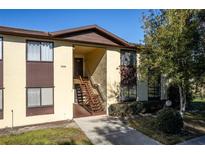 Front view of condo building with stairs and landscaping at 512 Bahia Cir # 512B, Ocala, FL 34472