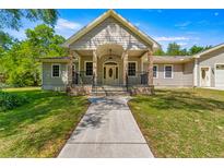 House exterior featuring stone accents and a covered porch at 10320 Sw 103Rd Ct, Ocala, FL 34481