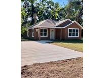 Charming one-story home featuring a new driveway, modern windows and a neutral color scheme at 13253 Se 35Th Ct, Belleview, FL 34420