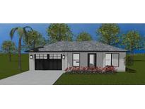 Modern house exterior with gray roof, black garage door, and landscaping at 2021 Nw Buena Vista Rd, Dunnellon, FL 34431