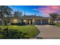 Charming one-story home with stone accents and a two-car garage at 3660 Se 54Th Ave, Ocala, FL 34480