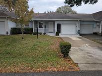 Front view of a single-story house with a garage and driveway at 9395 Sw 97Th Ln # B, Ocala, FL 34481