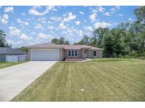 Newly constructed home with a large yard and attached garage at 13076 Sw 38Th Ter, Ocala, FL 34473