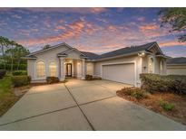 Single-story home with attached garage and manicured landscaping at 4911 Sw 63Rd Loop, Ocala, FL 34474