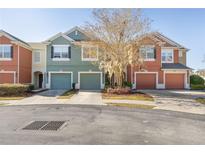 Three-unit townhome building with attached garages and landscaping at 4947 Sw 45Th Cir, Ocala, FL 34474